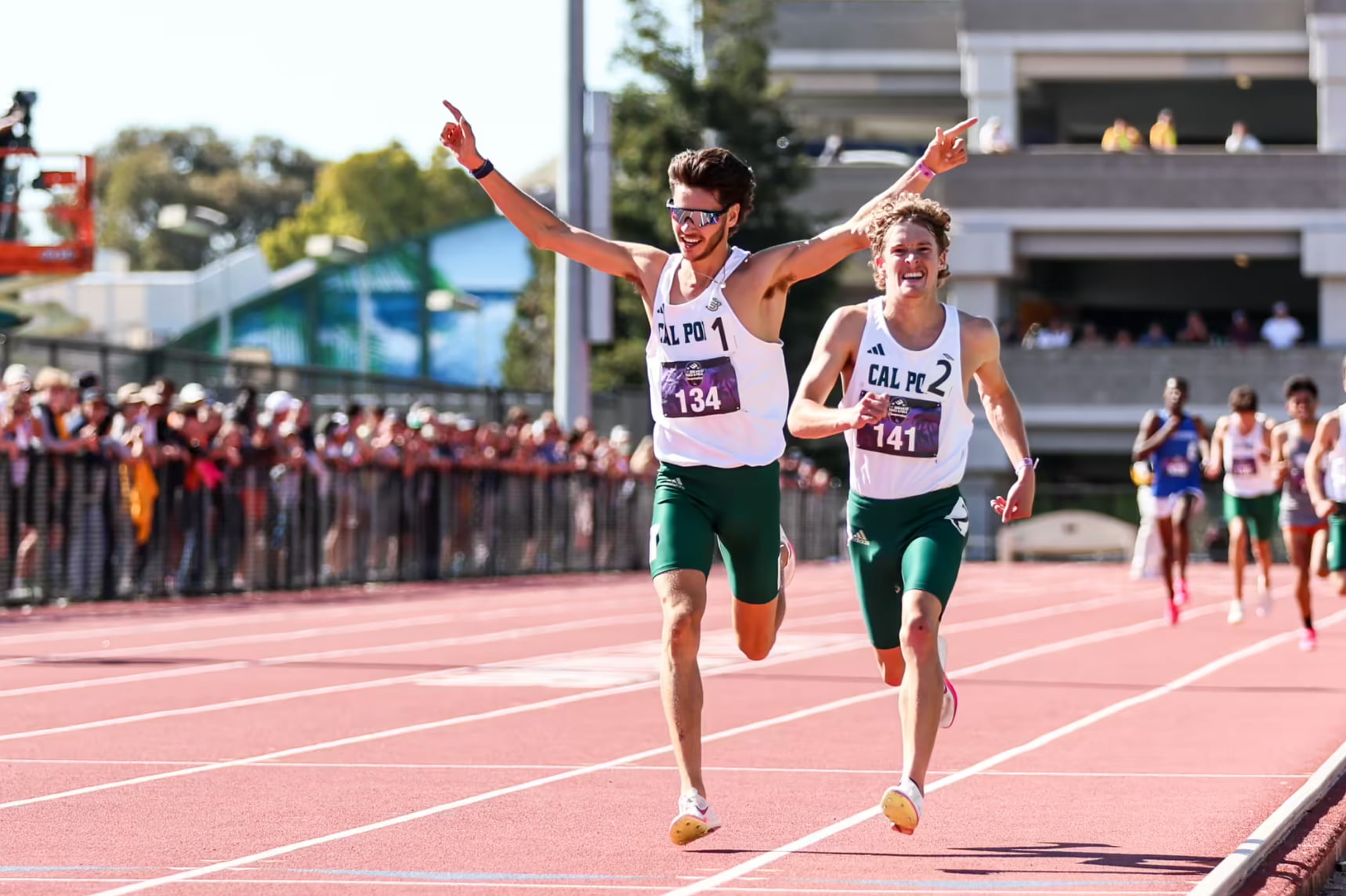 Davis Bove crosses the finish line at an outdoor track meet