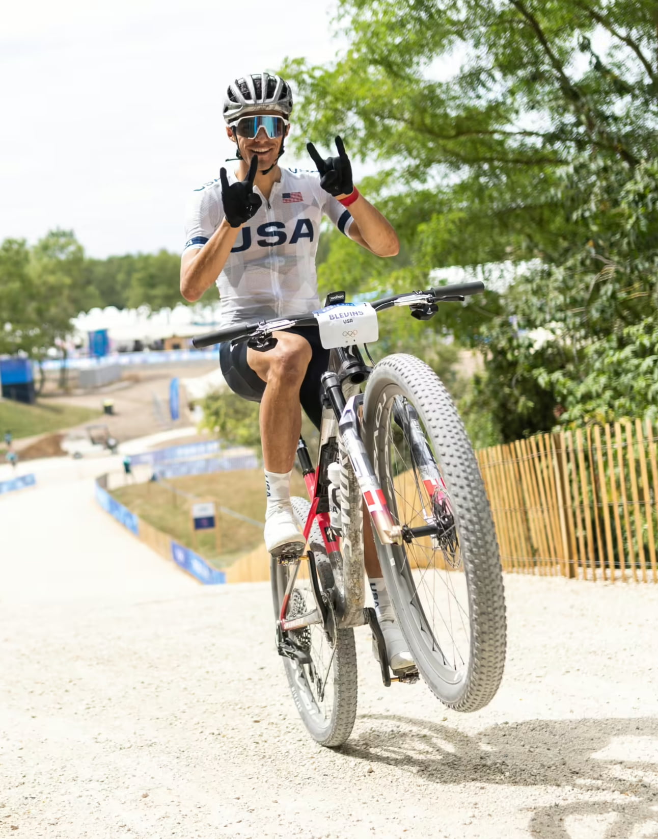 Christopher Blevins greets a camera while on his mountain bike