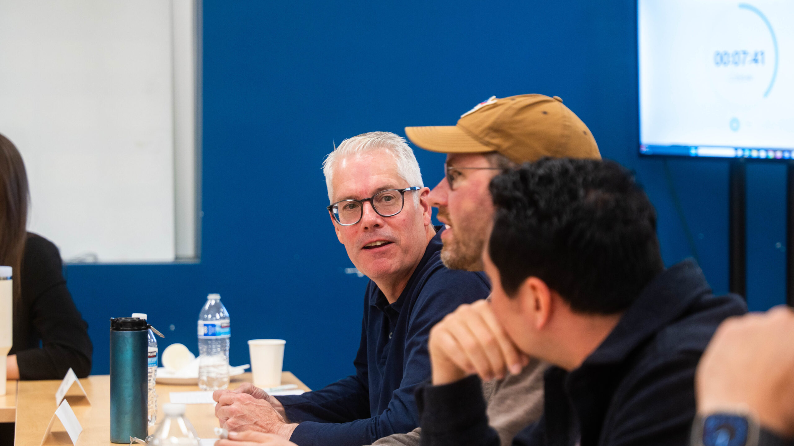 Judges on a panel discuss startup contestants