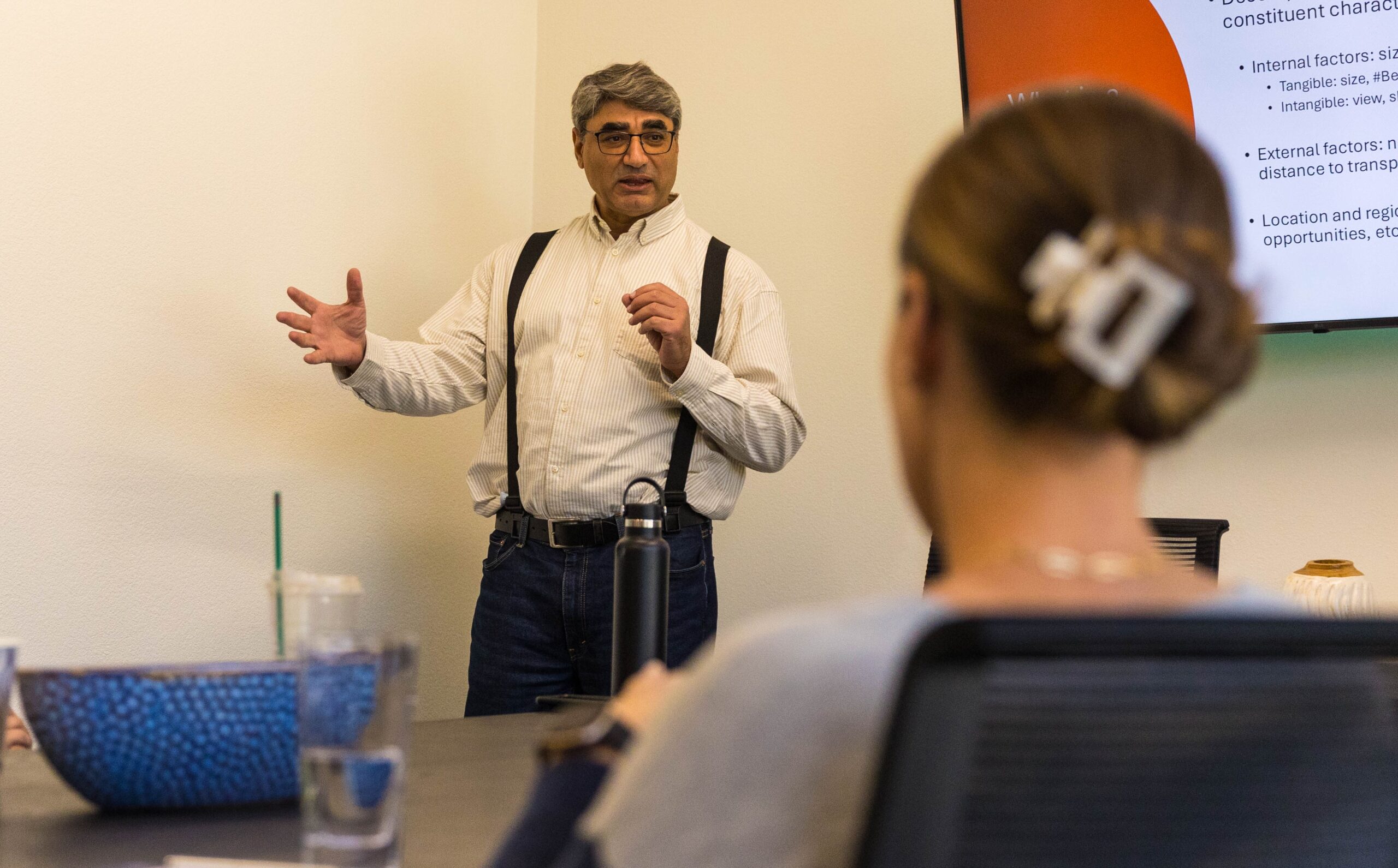 A professor speaks to a room of real estate experts