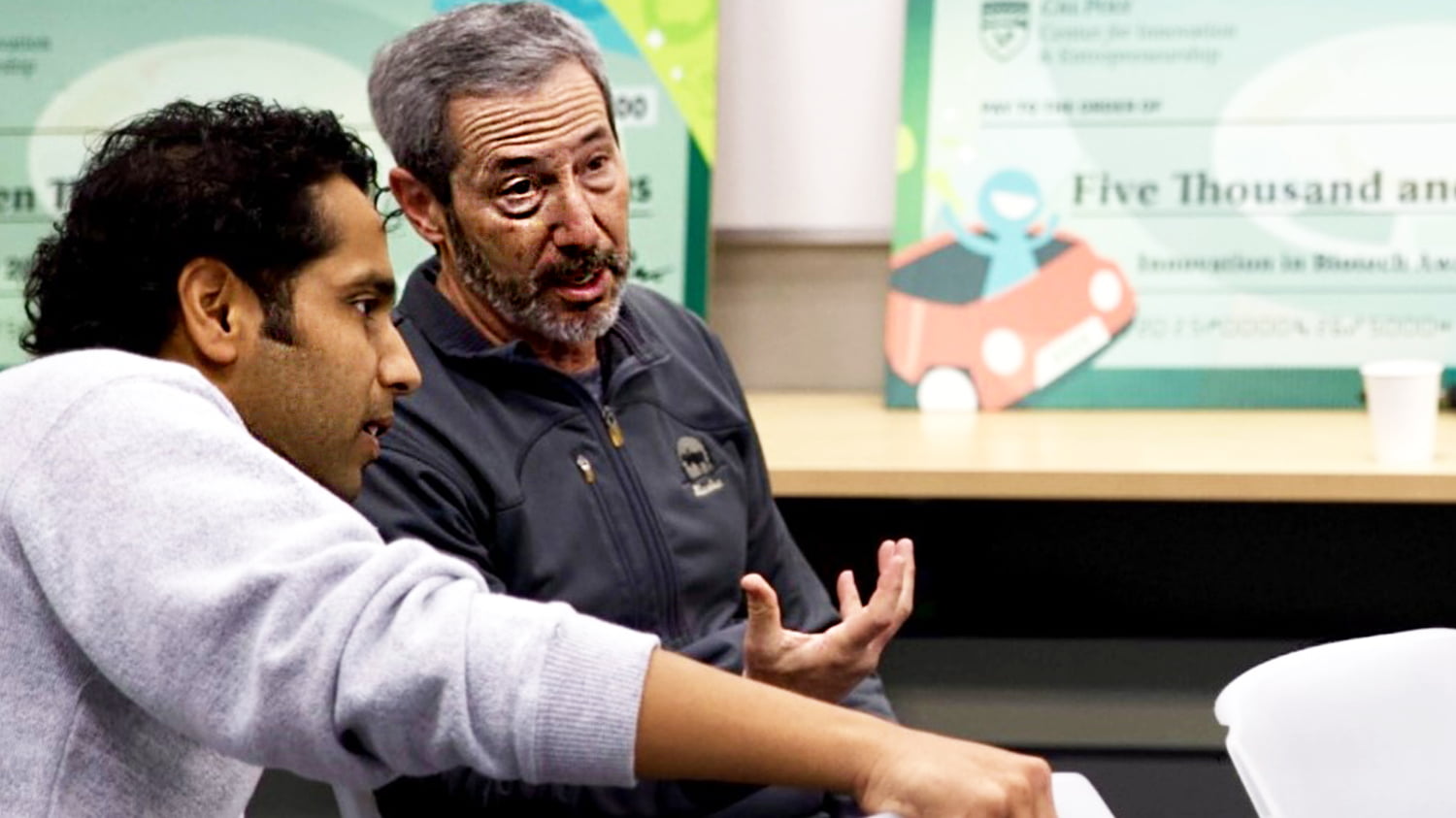 A CIE mentor speaks with a student entreprenuer