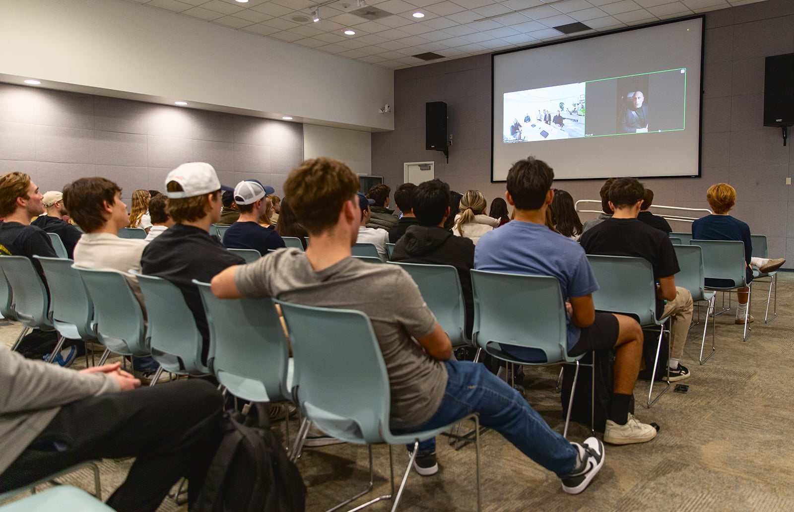 A crowd of students watches a virtual chat with Marc Lore at Cal Poly