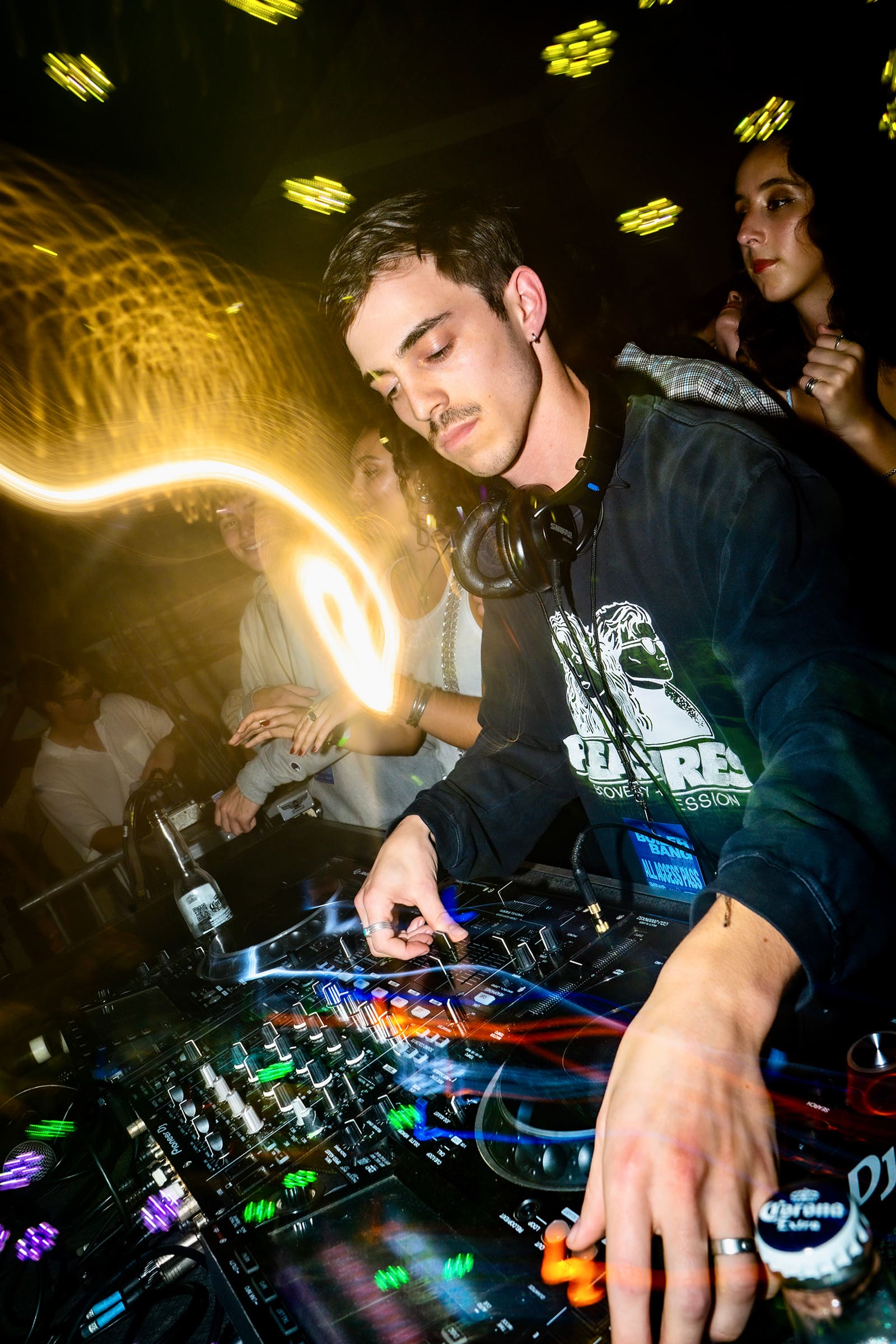A DJ performs with a mizing board