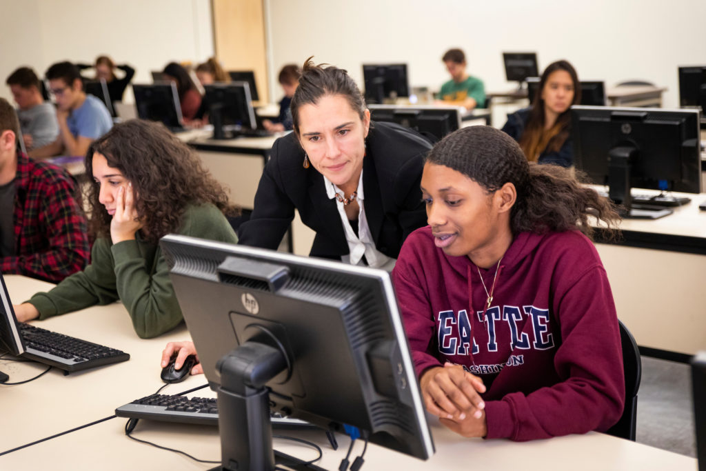Katya Vasilaky assisting students in her economics class