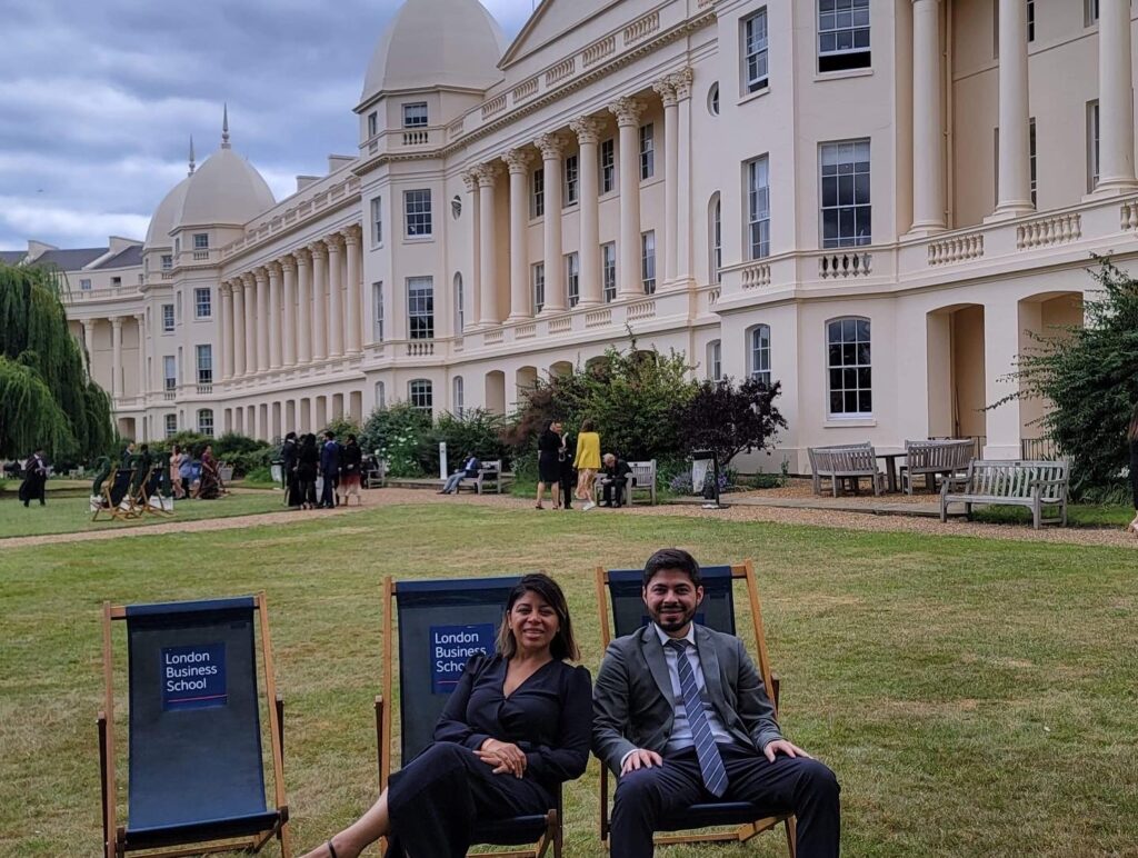 Carlos Noe Saavedra and friend on the lawn in front of the London Business School.