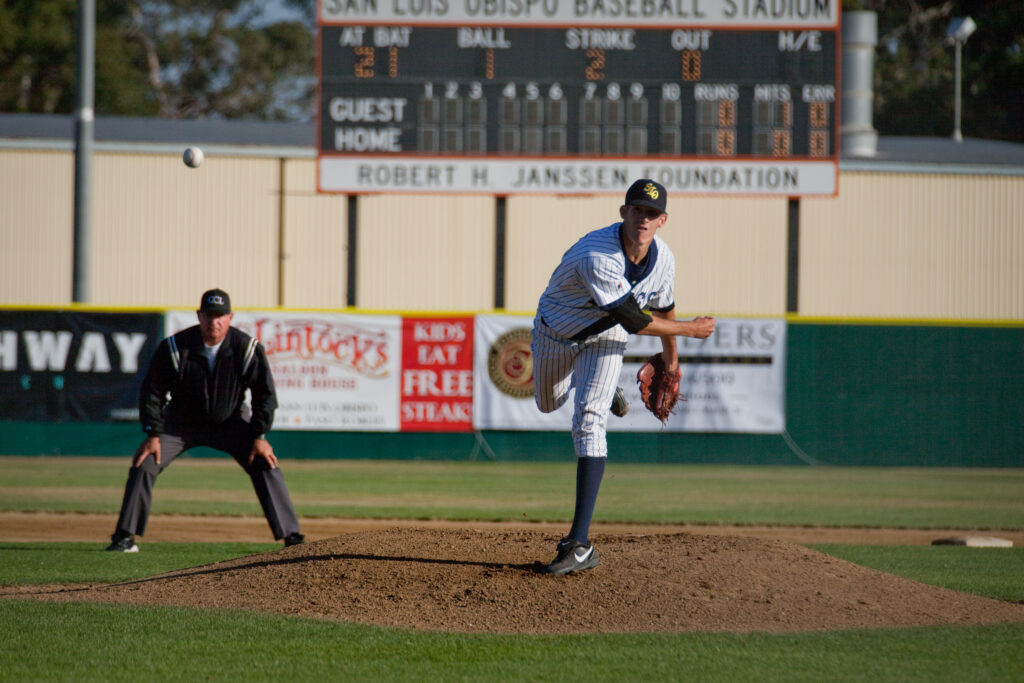 San Luis Obispo Blues pitcher on the mount, having just thrown a pitch.