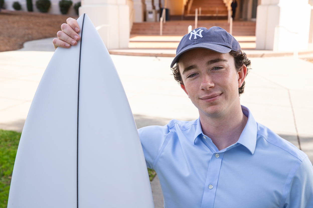 Brandon Williams poses with a surfboard
