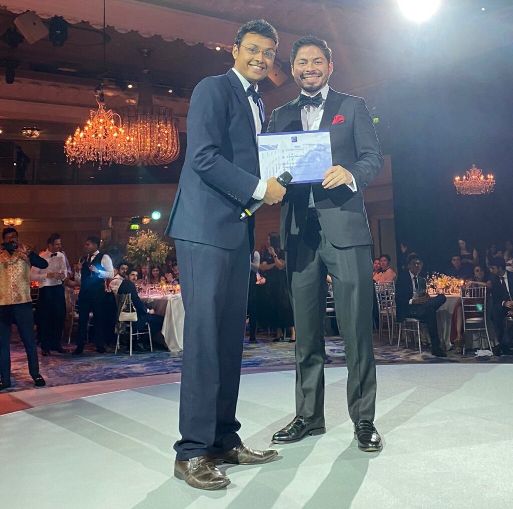 Carlos Noe Saavedra posing with his diploma from the London Business School.