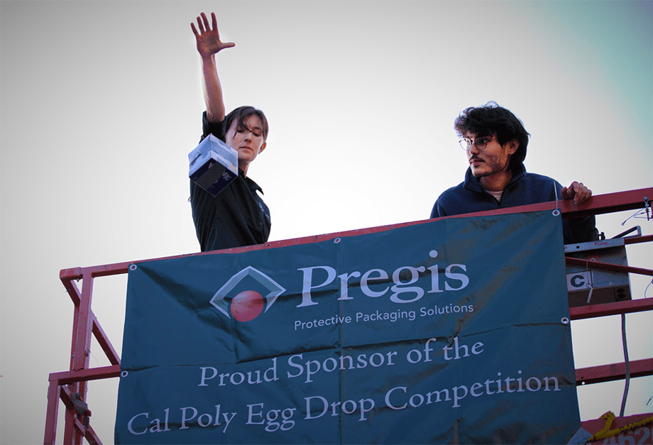 Two people on a scissor lift, one dropping an egg at the Egg Drop