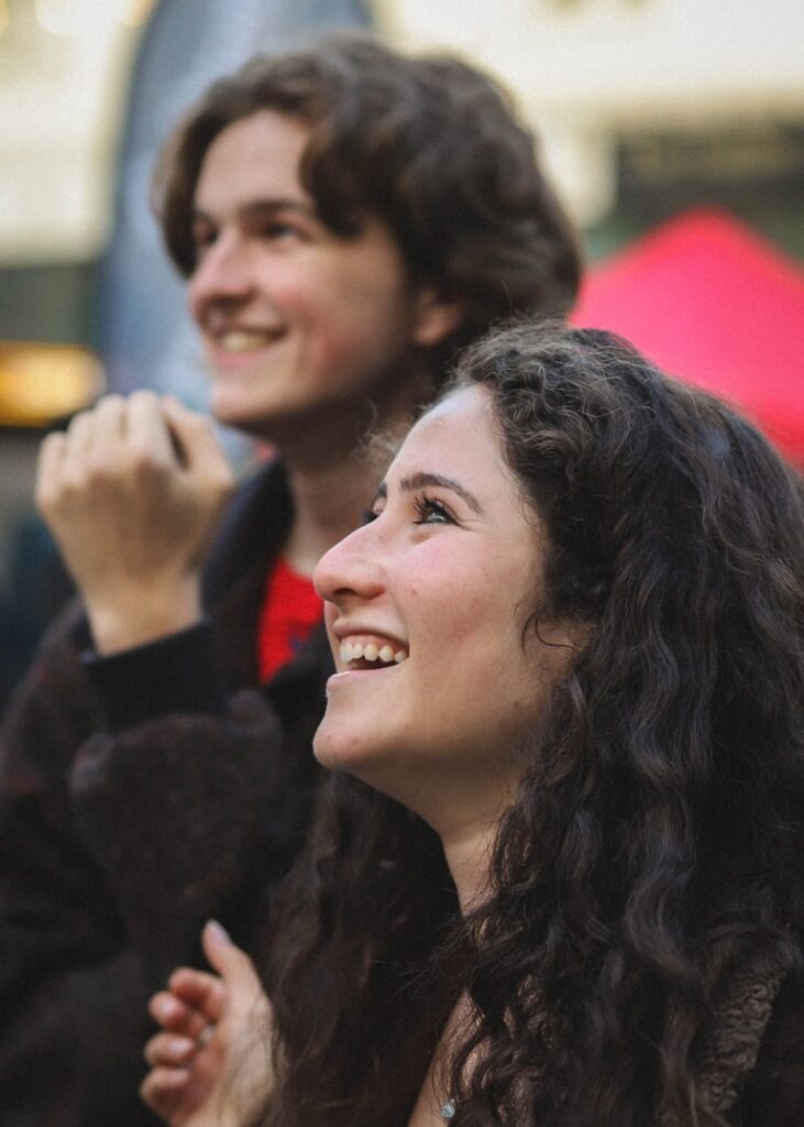 Two people looking up as eggs are dropped from the scissor lift