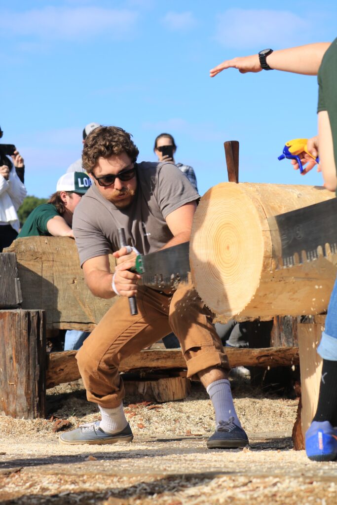 Nate Mirizzi sawing a log in a contest