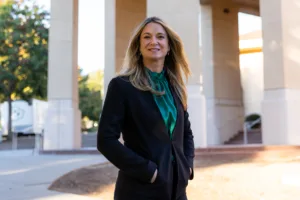 Kelly Dye poses for a portrait outside the business building at Cal Poly