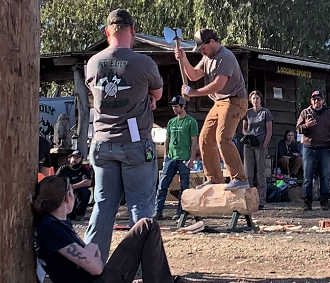 Nate Mirizzi chopping a long he is standing on