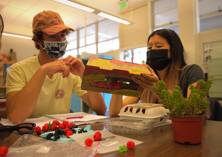 Industrial Technology and Packaging students working on a model.