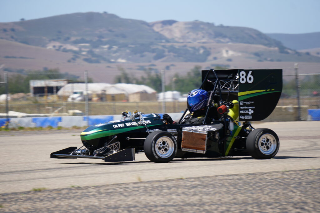 Tommy Bordeaux, a finance student, driving a Cal Poly Formula race car.
