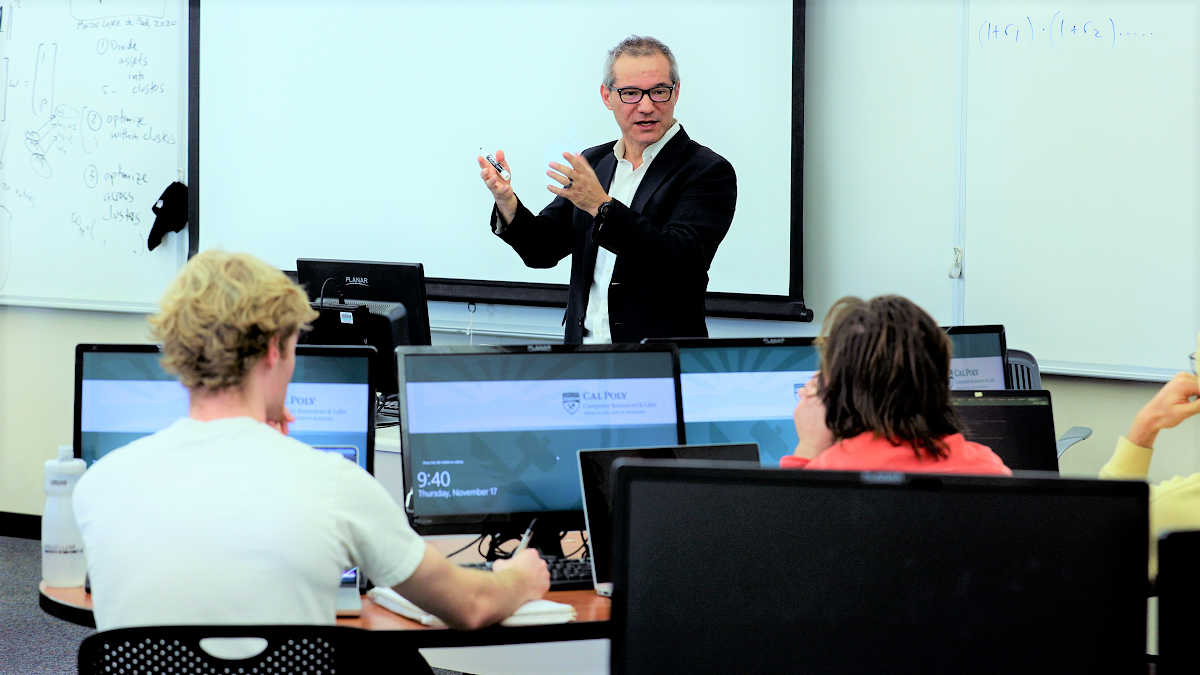 An economics professor teaches a class