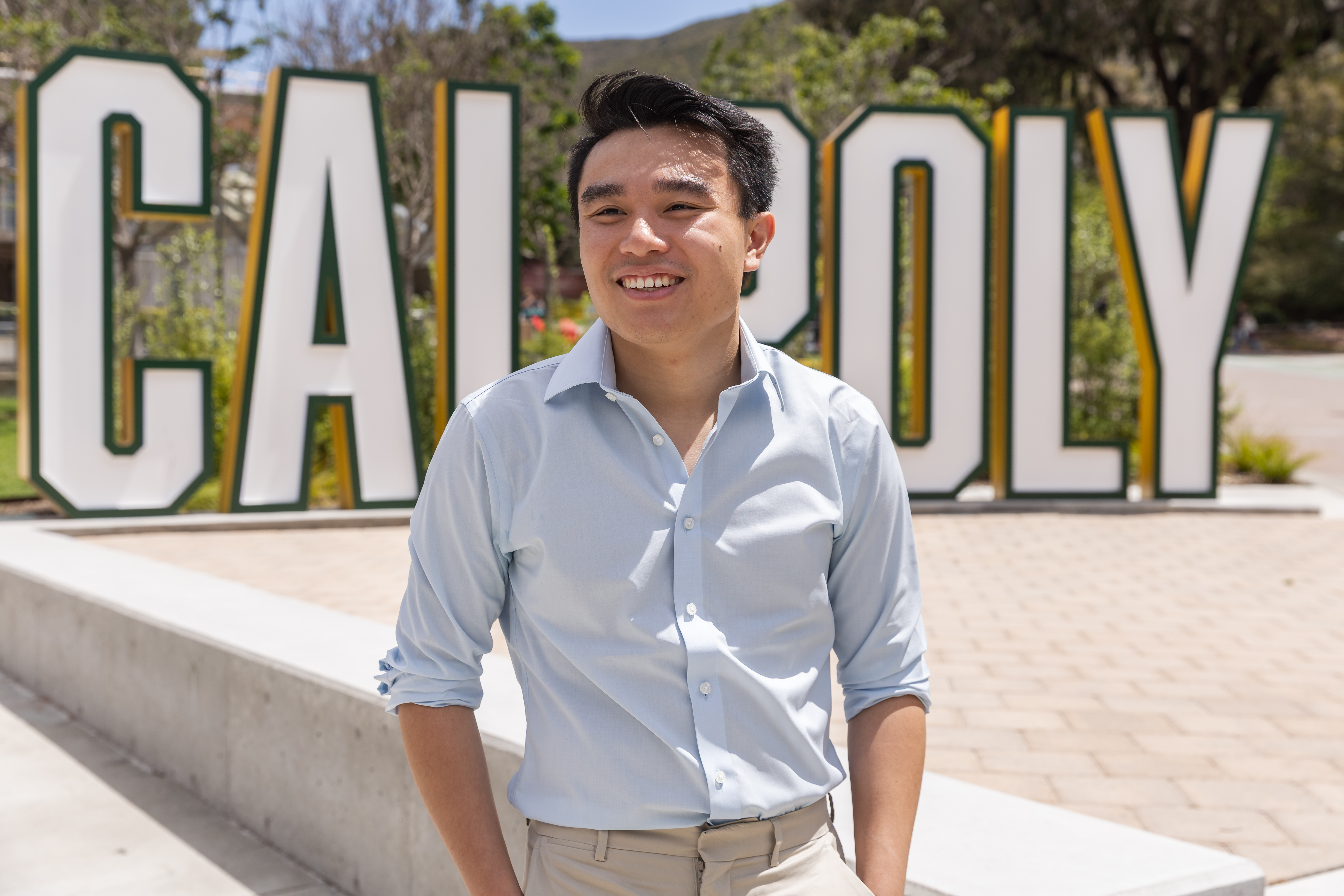 Randy Tran portrait in front of Cal Poly sign