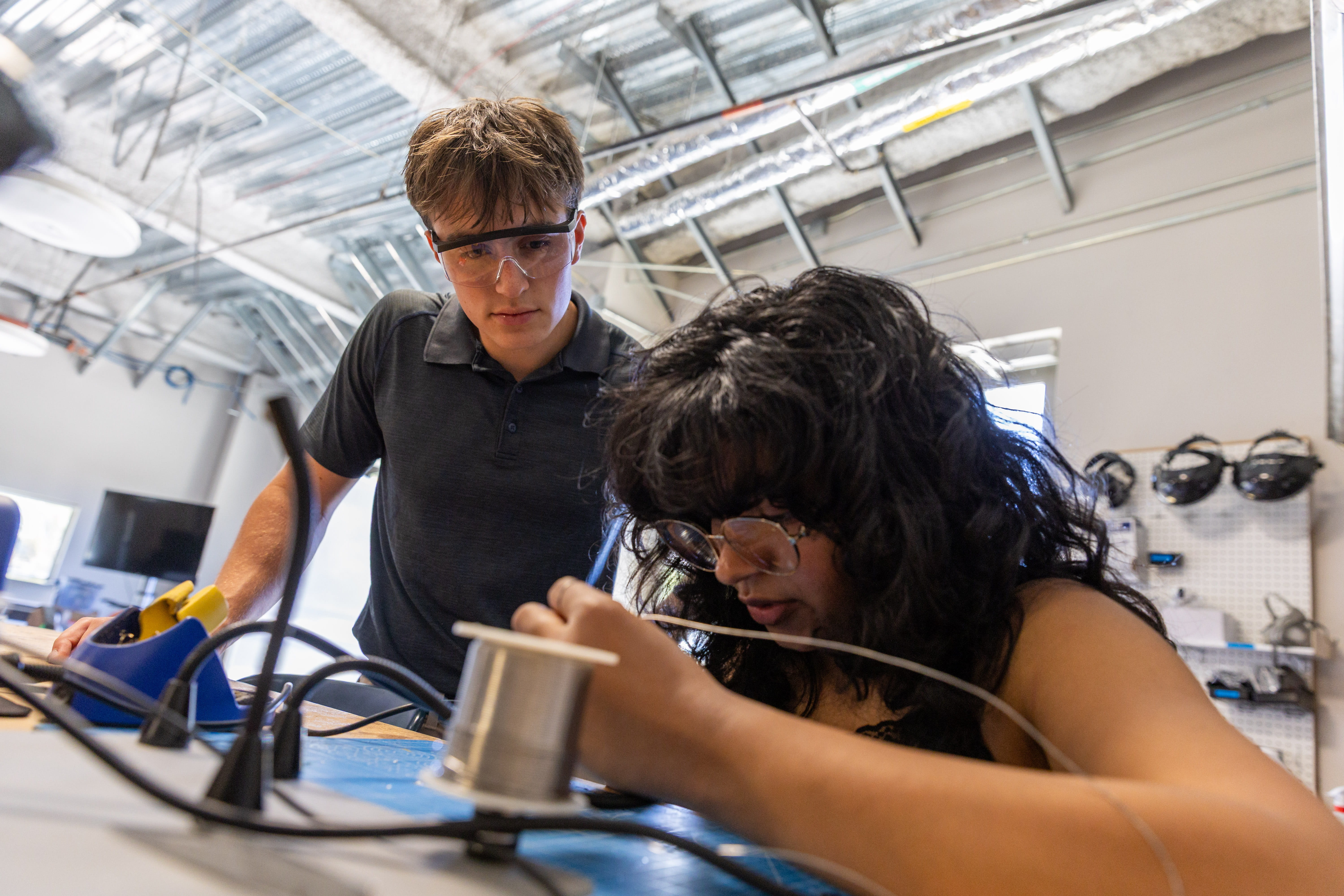Miles Clarke speaks with a student working in the EMPOWER lab