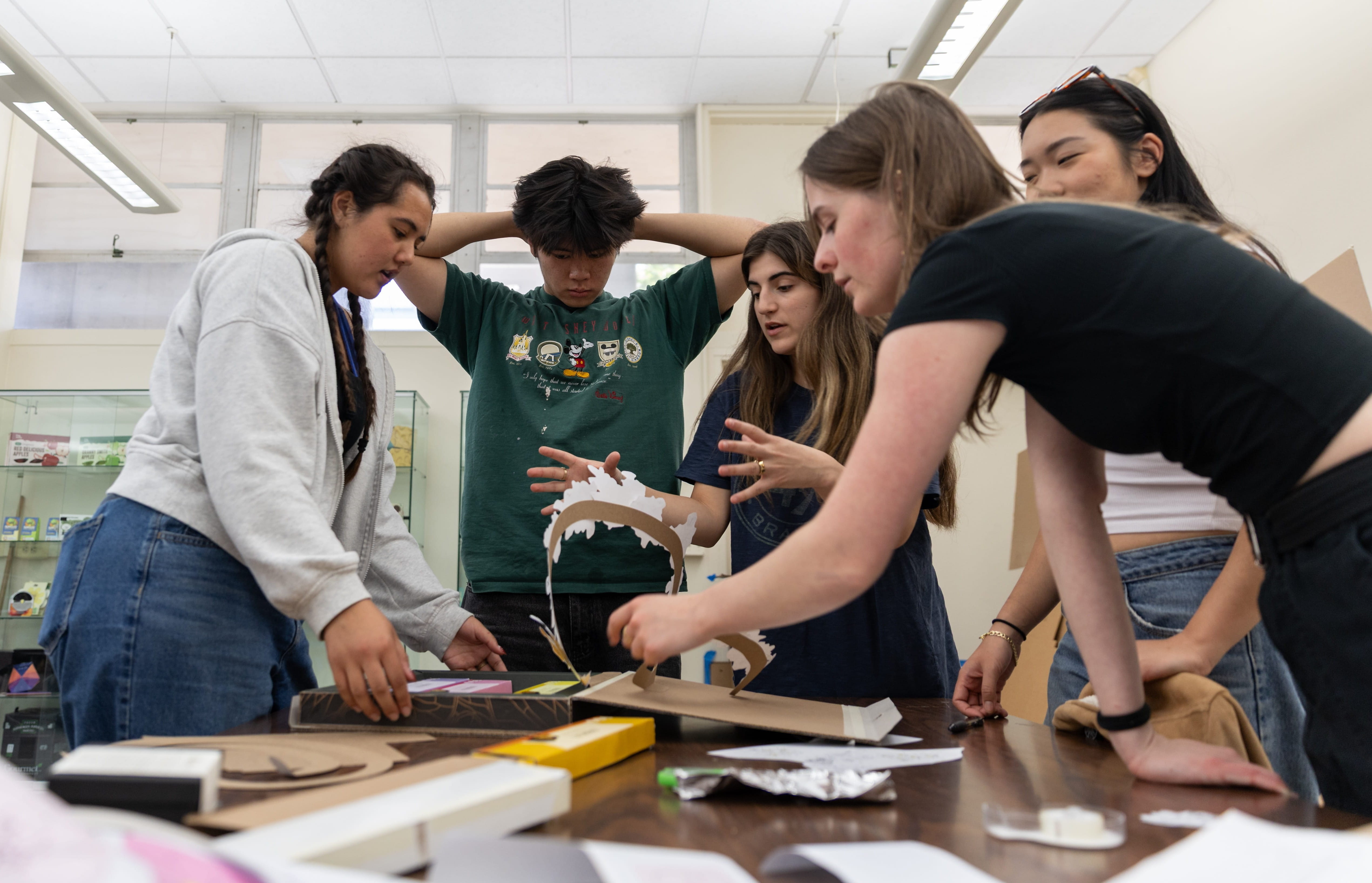 A group of students work in a lab to create a packaging project