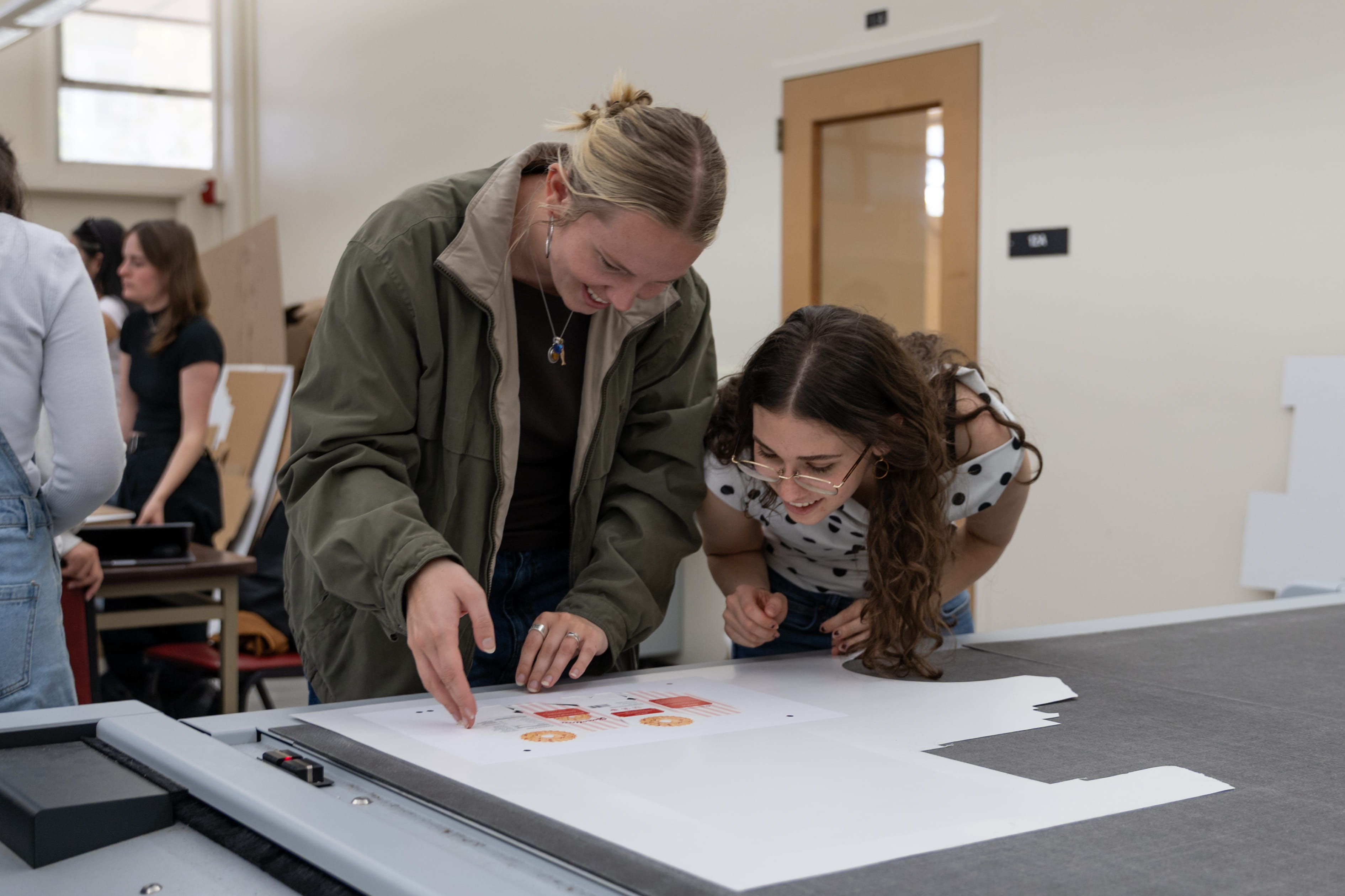 Two students work on a packaging project in the lab