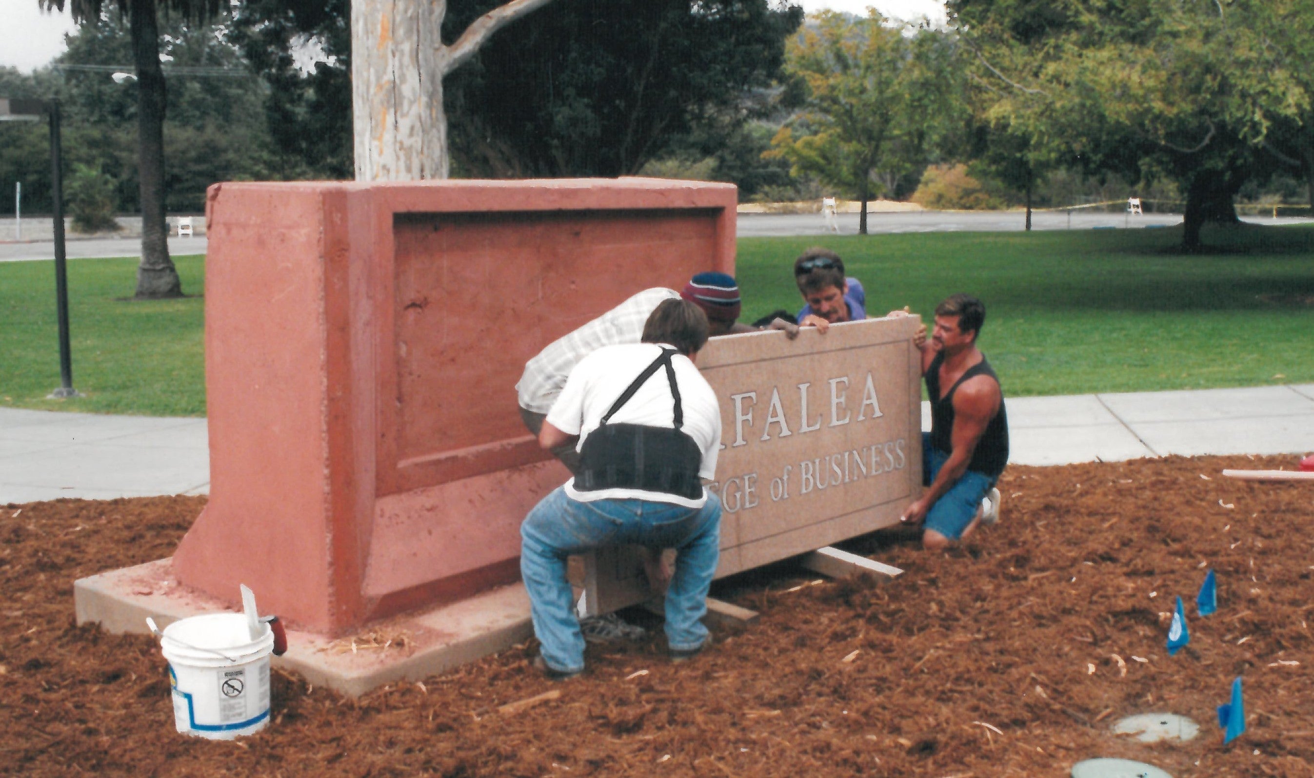 Workers install the Orfalea College of Business sign