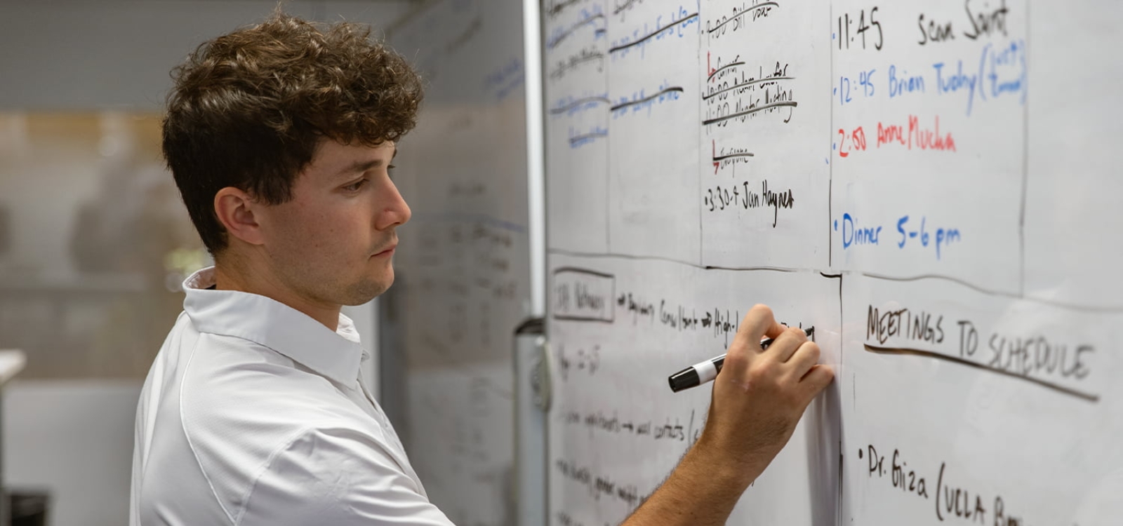 A student writes on a white board