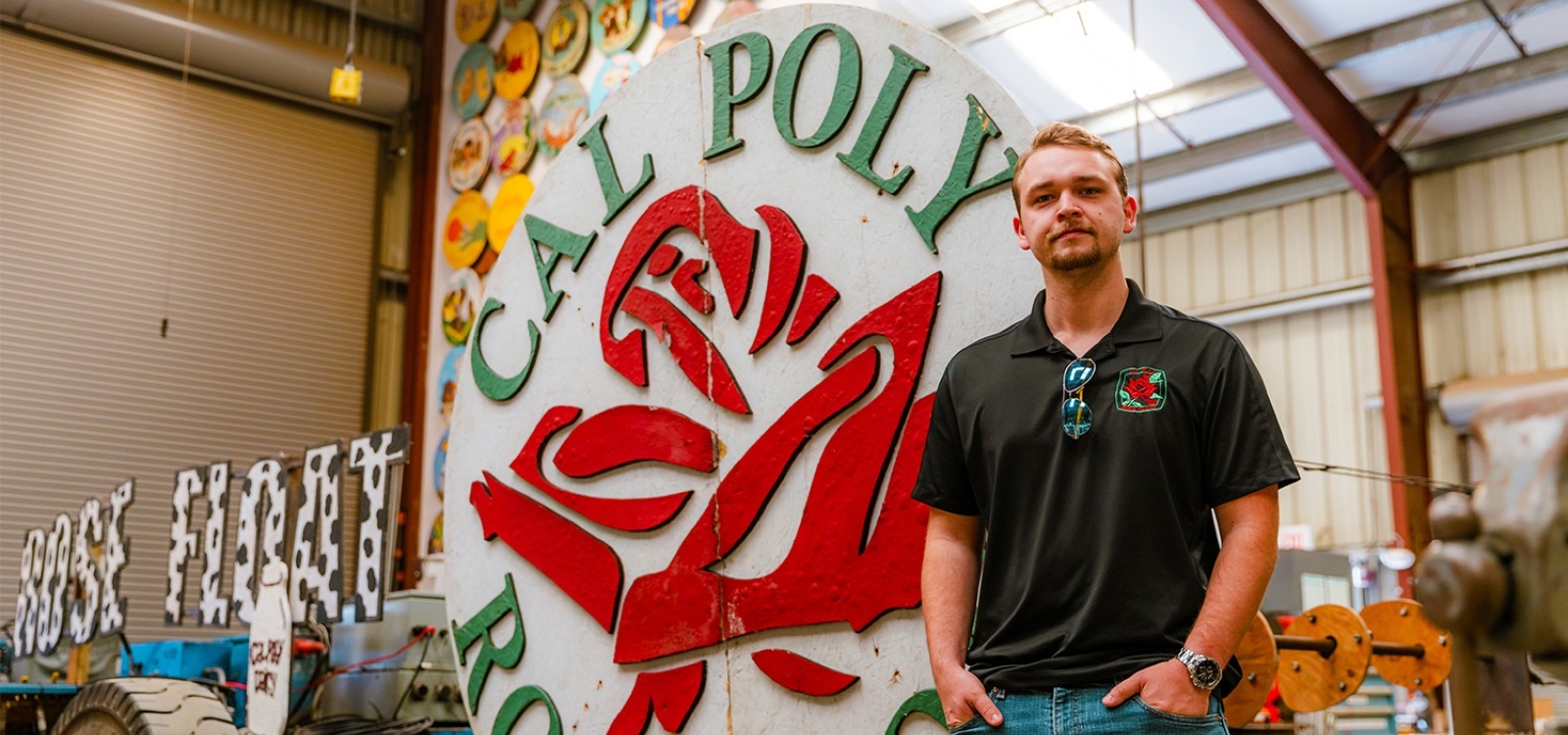 A student poses for a portrait in the Rose Float shed