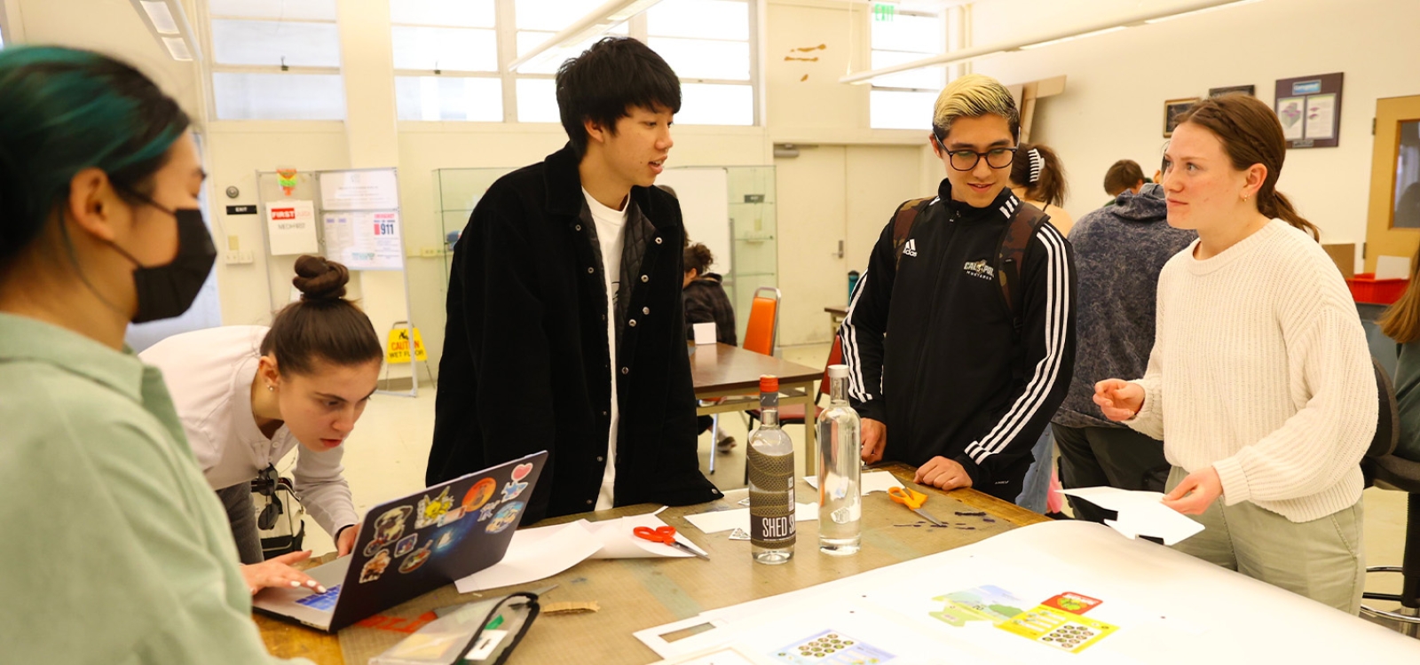 A team of students works on packaging for an imaginary sunscreen product.