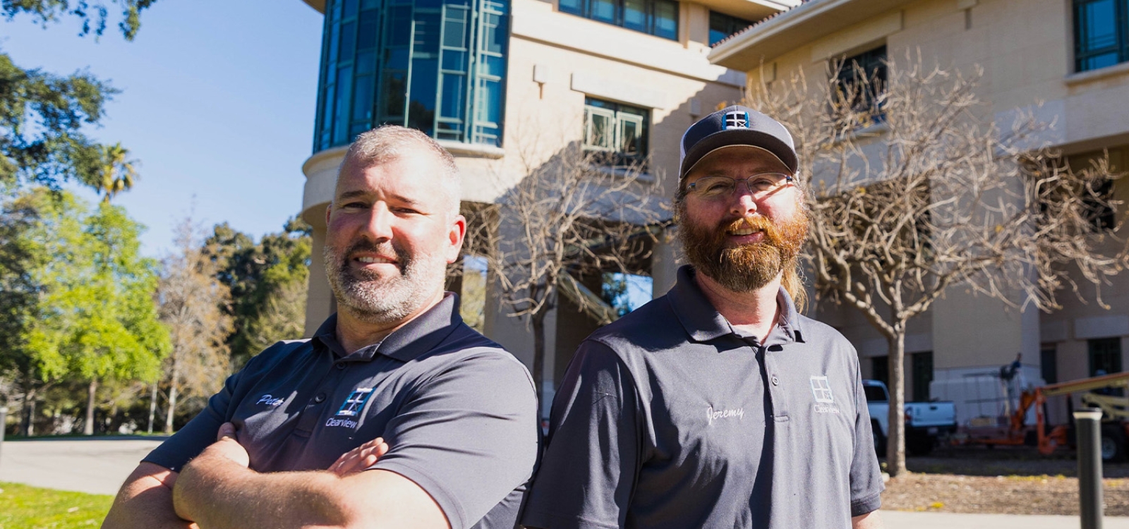 The owners of Clearview window washing pose for a portrait