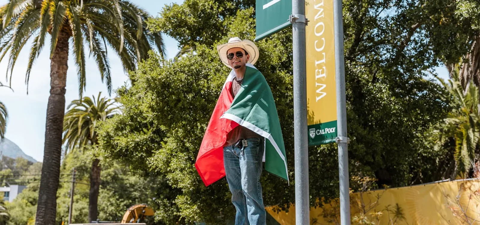 Student poses with Mexican flag around shoulders