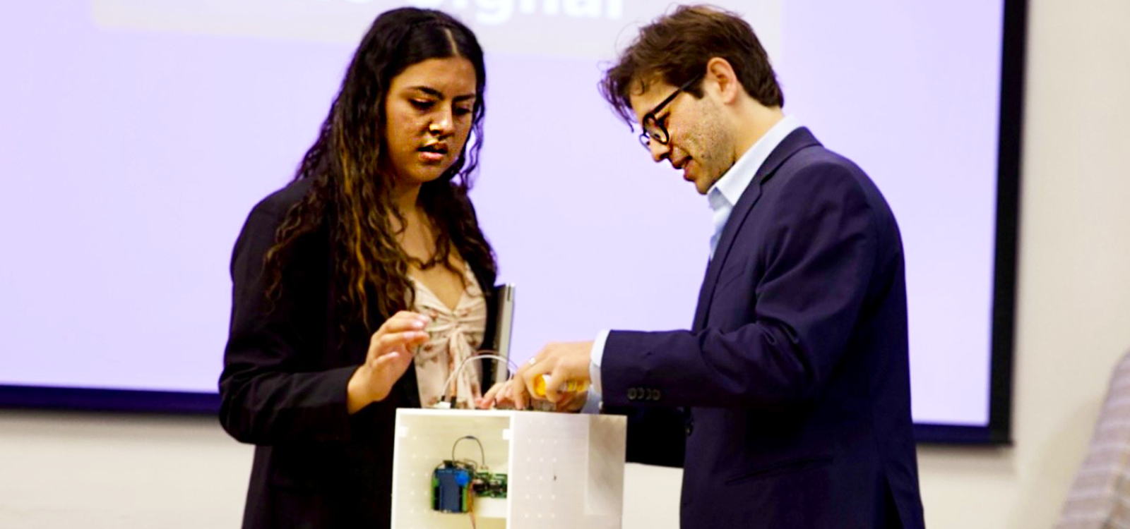 Two students demonstrate a medical device