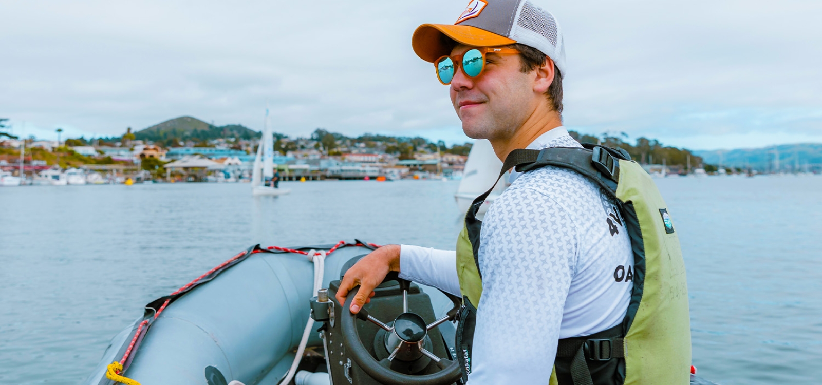 Cal Poly business student Nathan Briar steers a boat in Morro Bay Harbor