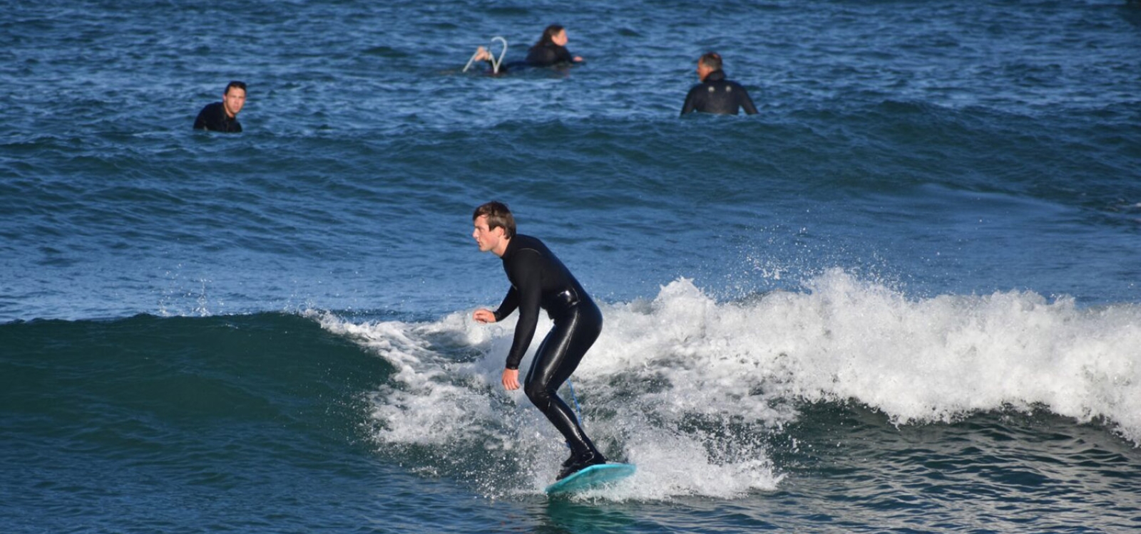 Jackson Prudhon riding a wave next to Morro Rock.