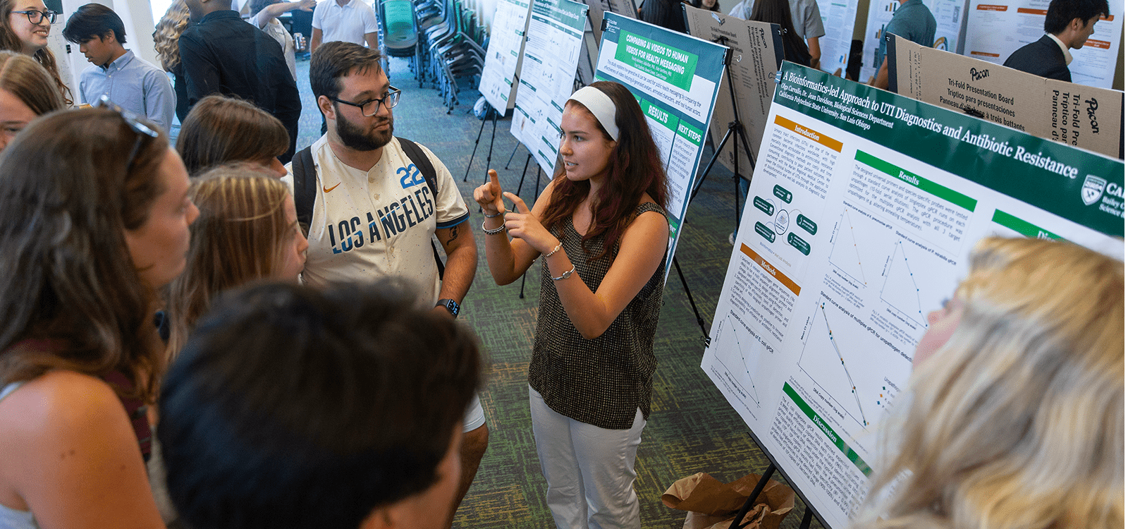 A student discuss her research project during the SURP Symposium