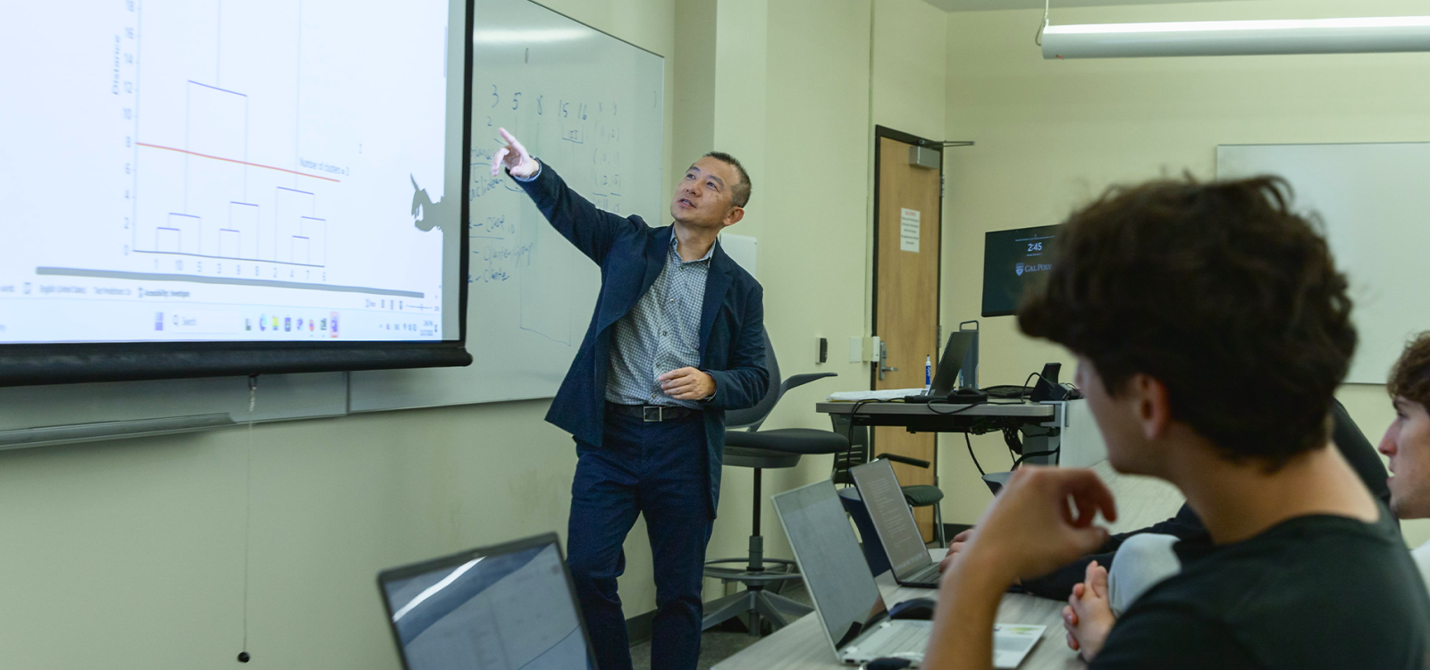 Leida Chen, teaching at the front of a classroom