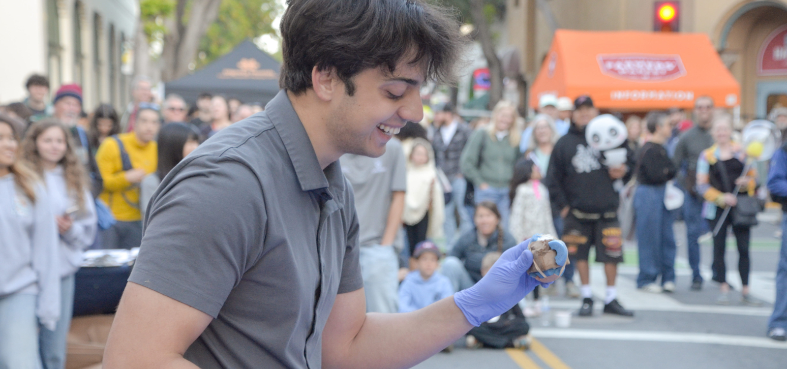 A packaging student inspects a fallen egg