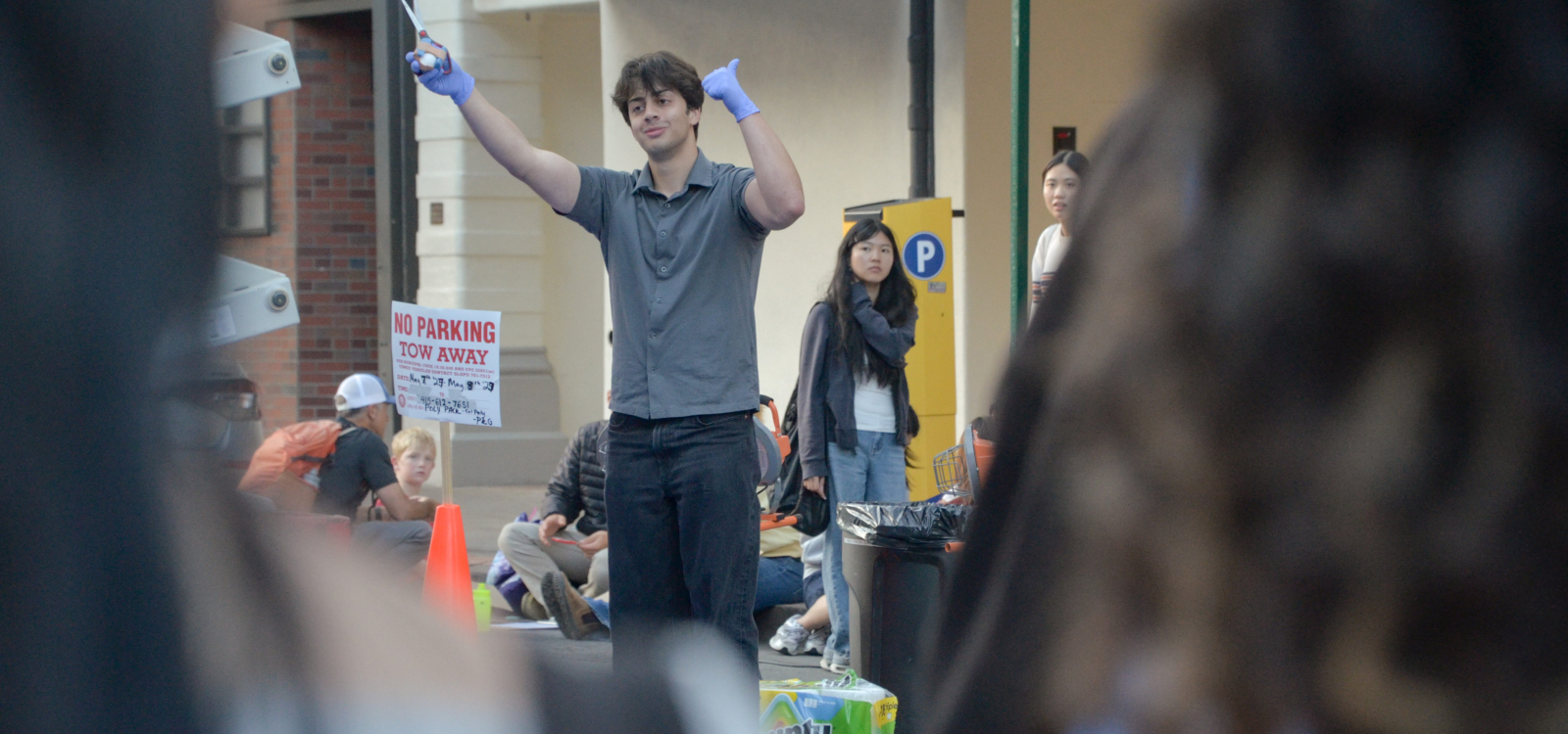 A student raises an egg freed from its package after a drop