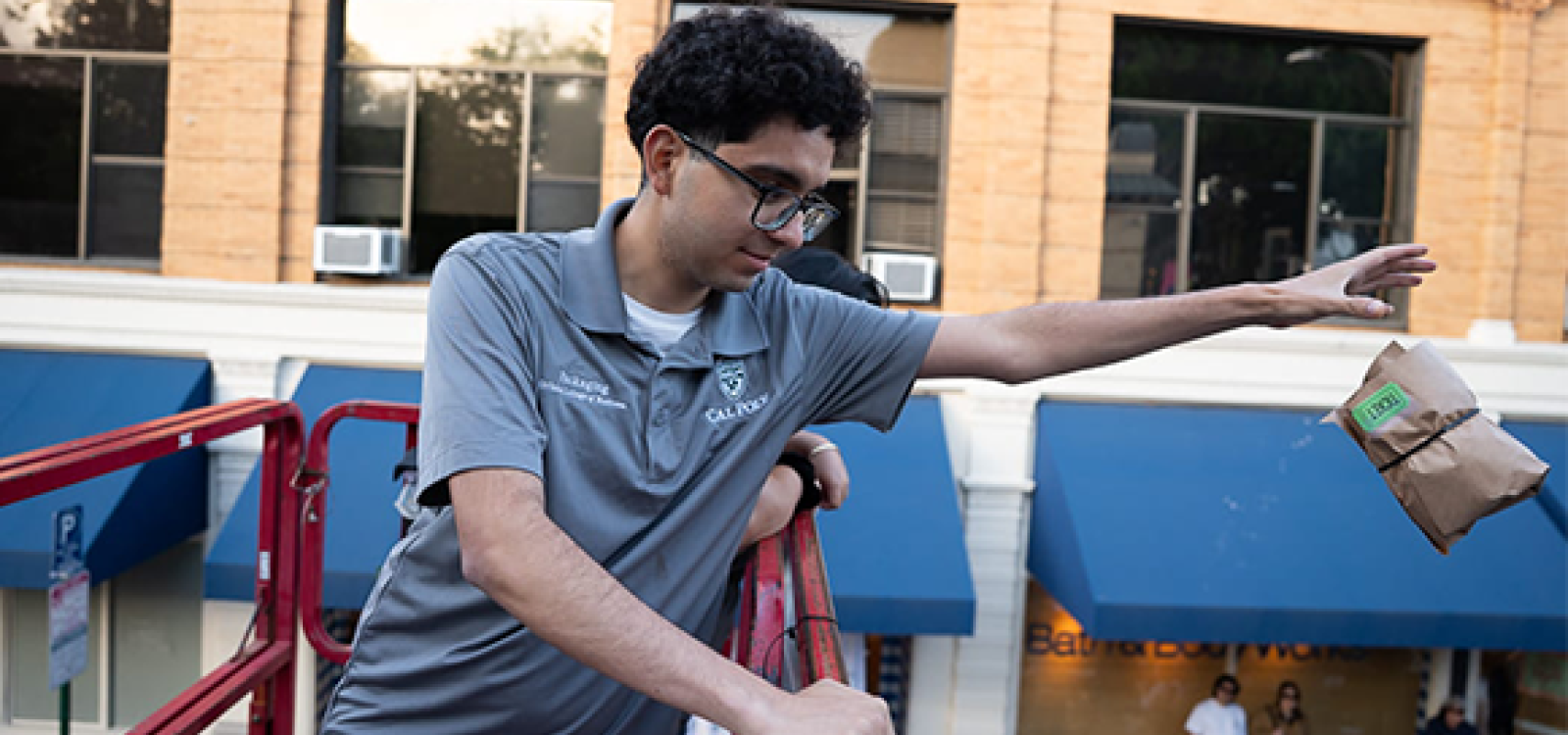 A student drops a packaged egg