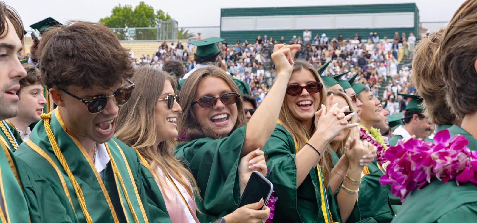 Students dance in their seats at commencement