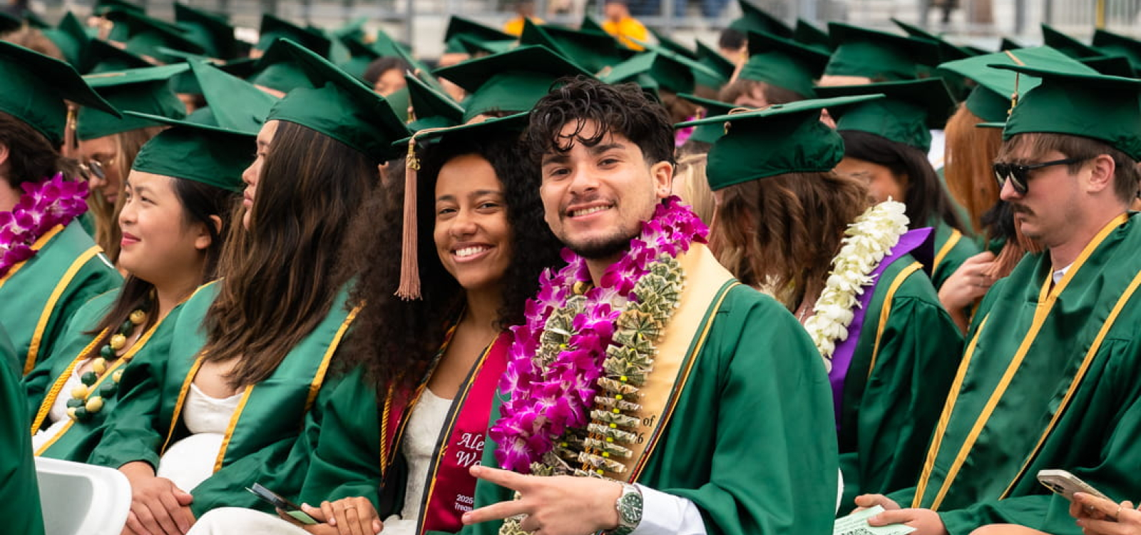 Students in caps and gowns prepare for commencement
