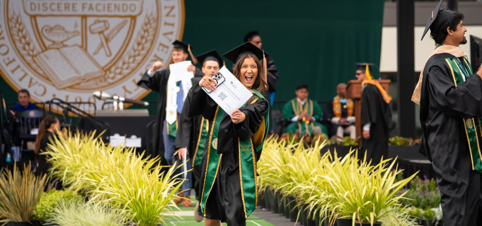 A graduating student shows off her new degree