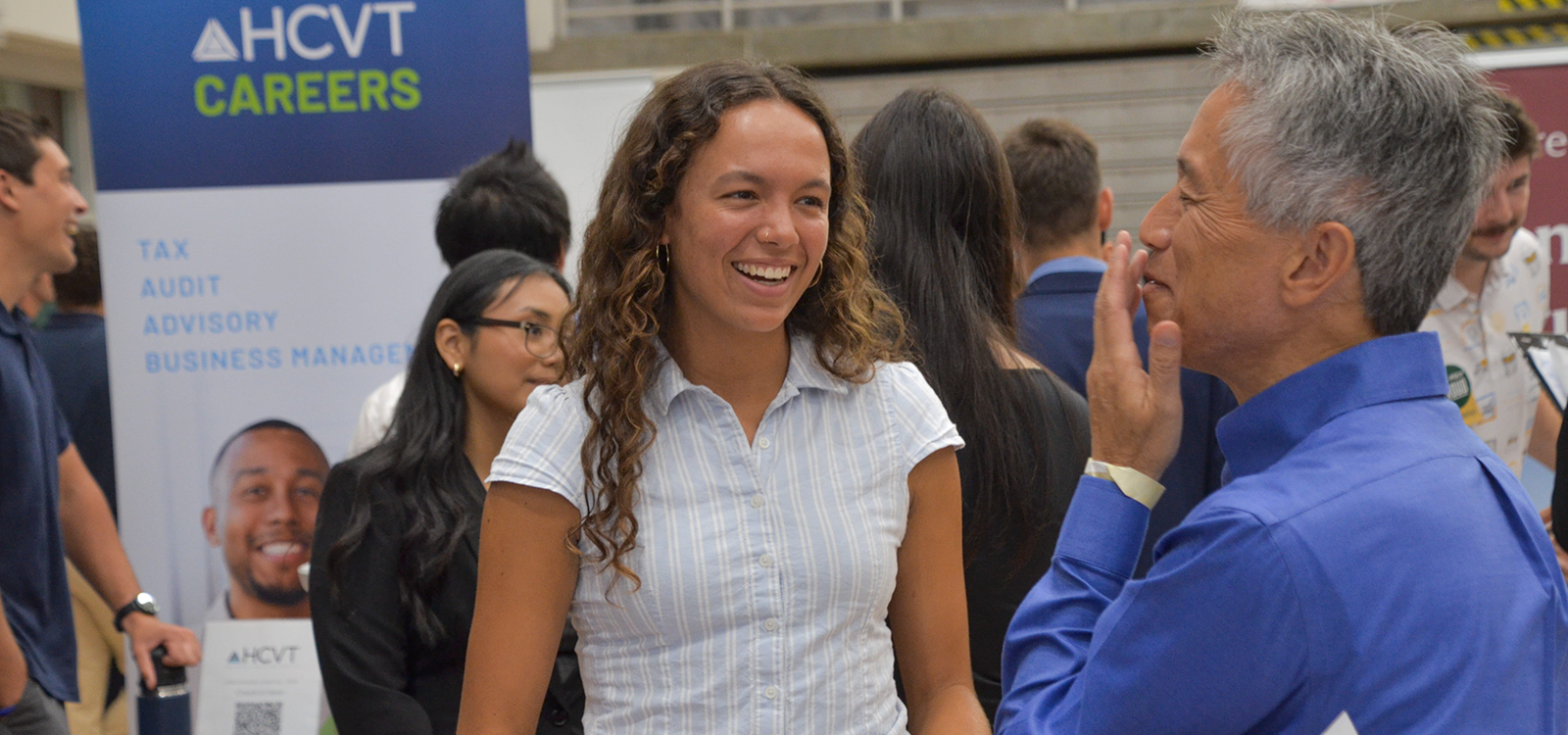 Recruiters and students mingle at a career fair.