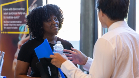 Student chats with corporate partner
