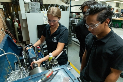A student works on a machine for her capstone class