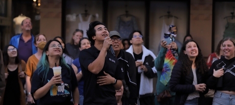 A group of people looking up at the Egg Drop Competition put on by the Poly Pack club.