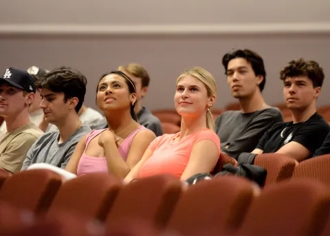Business students listening to a pipe organ performance 