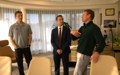Dean Damon Fleming speaks with members of a student club in his office