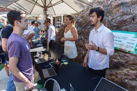 Students presenting their innovations at an outside venue during 2024 Demo Day