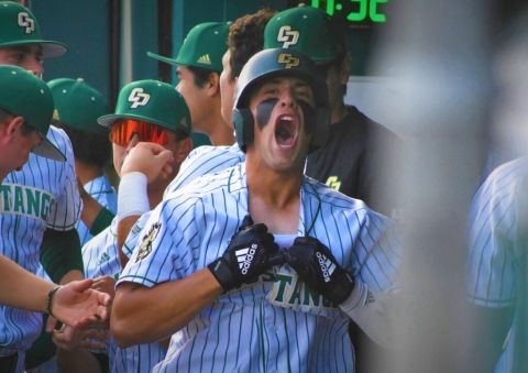 Cal Poly shortstop Brooks Lee celebrating in the dugout.