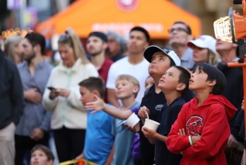 Children looking up, watching the egg drop competition.